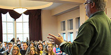 A speaker talks to an audience of students