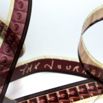 Film from a reel has been unwound and sweeps across the image