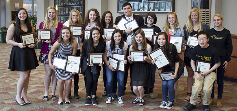 Members of the Student Journalist Staff hold their plaques for a photo.