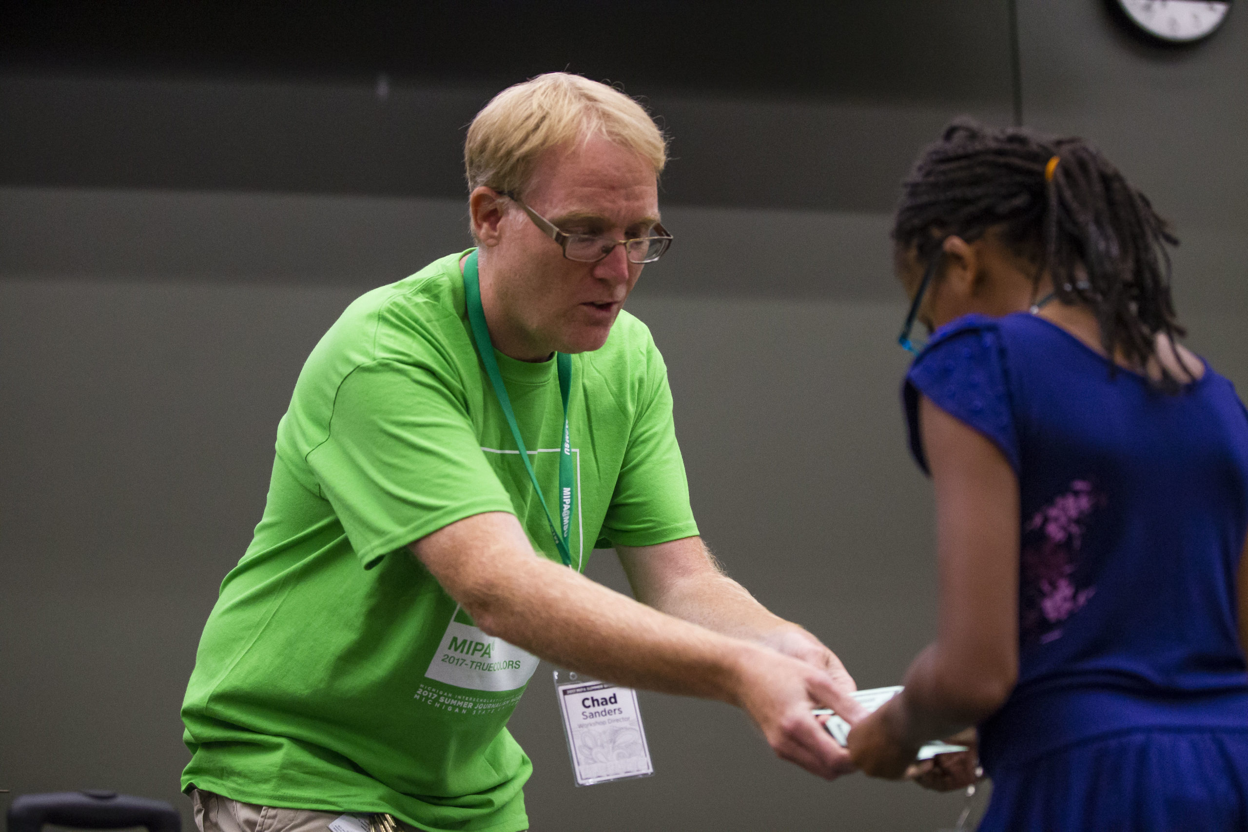 Chad Sanders hands out Chad Change at the opening session of MIPA Camp Sunday, July 30, 2017. MIPA Photo/Michael Caterina