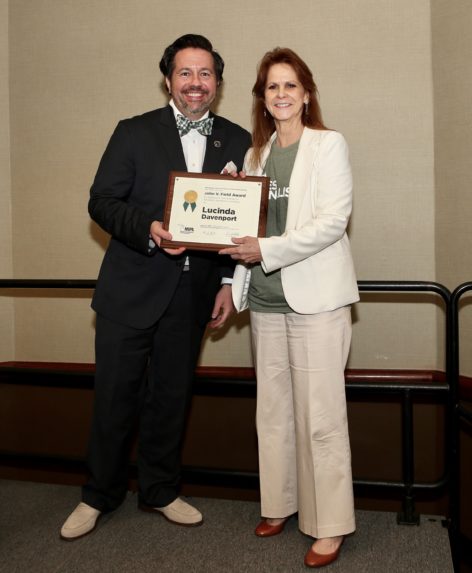MIPA Executive Director Jeremy Steele presented the John V. Field Award to Lucinda Davenport, director of the School of Journalism at Michigan State University.
