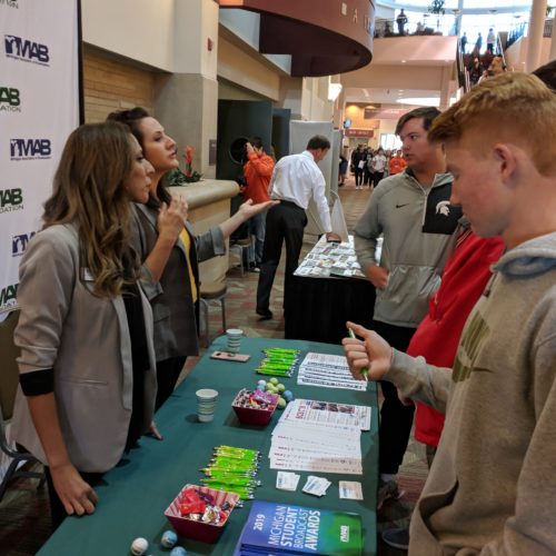 Representatives of the Michigan Association of Broadcasters Foundation talk with students at the MIPA fall conference.