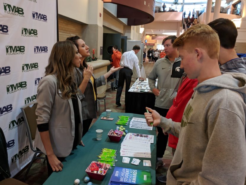 Representatives of the Michigan Association of Broadcasters Foundation talk with students at the MIPA fall conference.