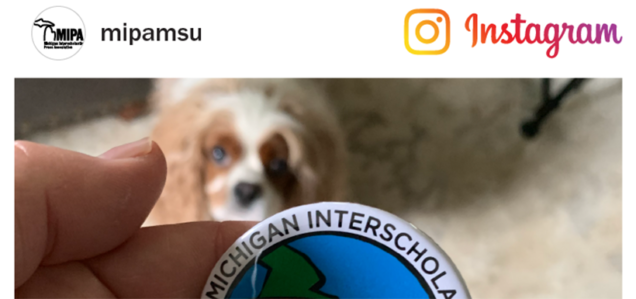 Screen shot of a MIPAMSU instagram post featuring a dog staring at Michigan Interscholastic Press Association button pin held in a hand.