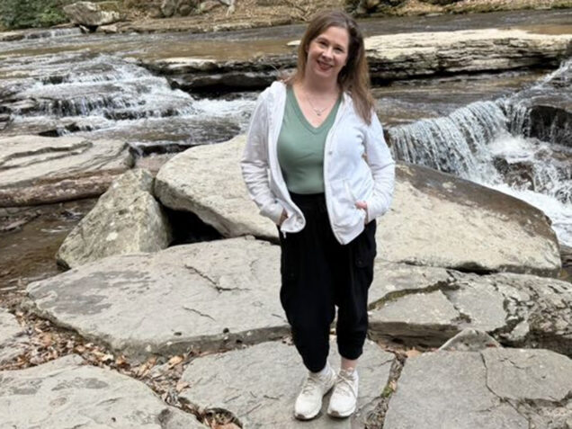 Erica Kincannon standing in front of a waterfall